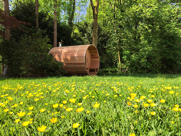 Saunabarrel barrel sauna on a summer day just before a forest.
